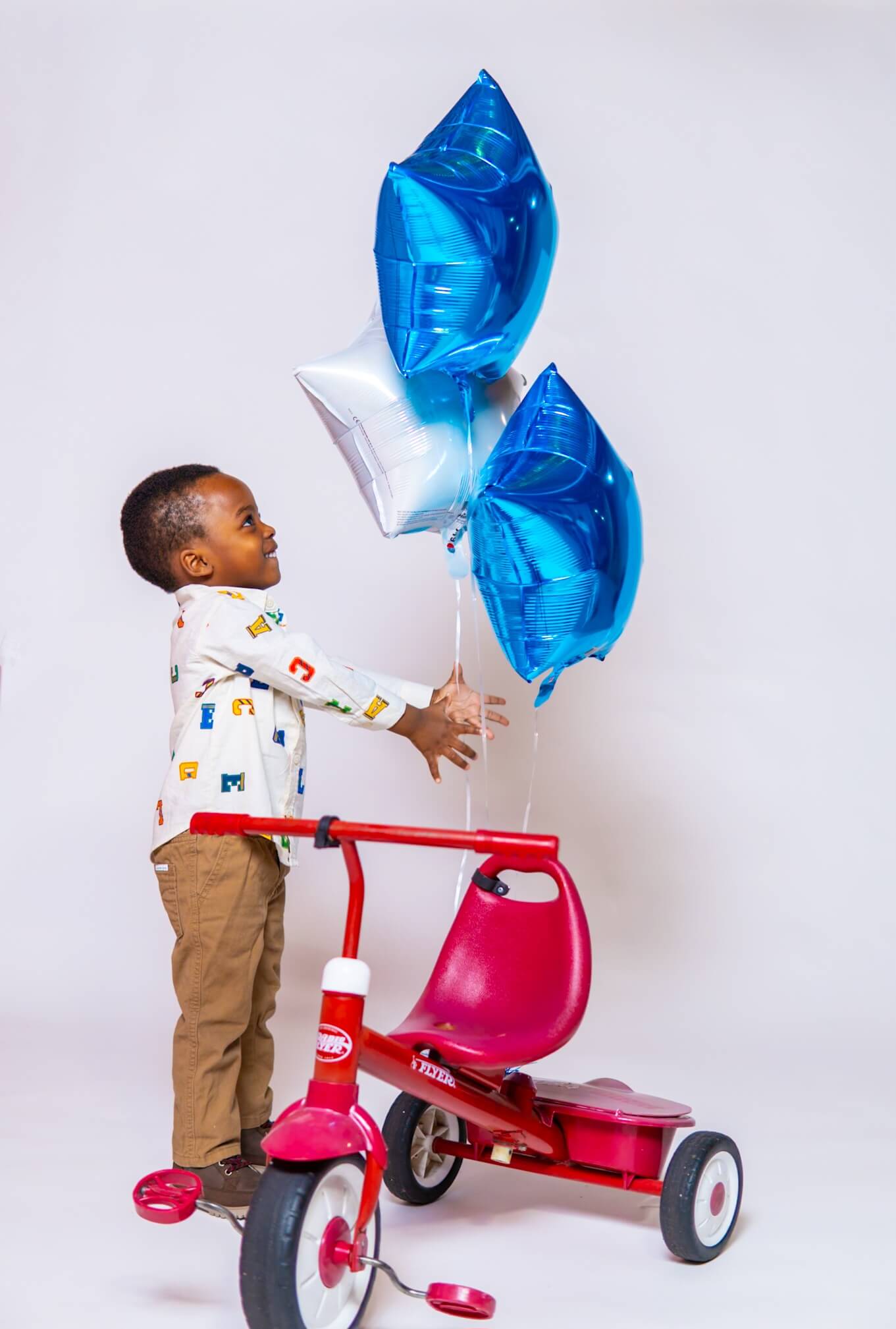 Full length portrait of a 3 year old boy in a studio setting