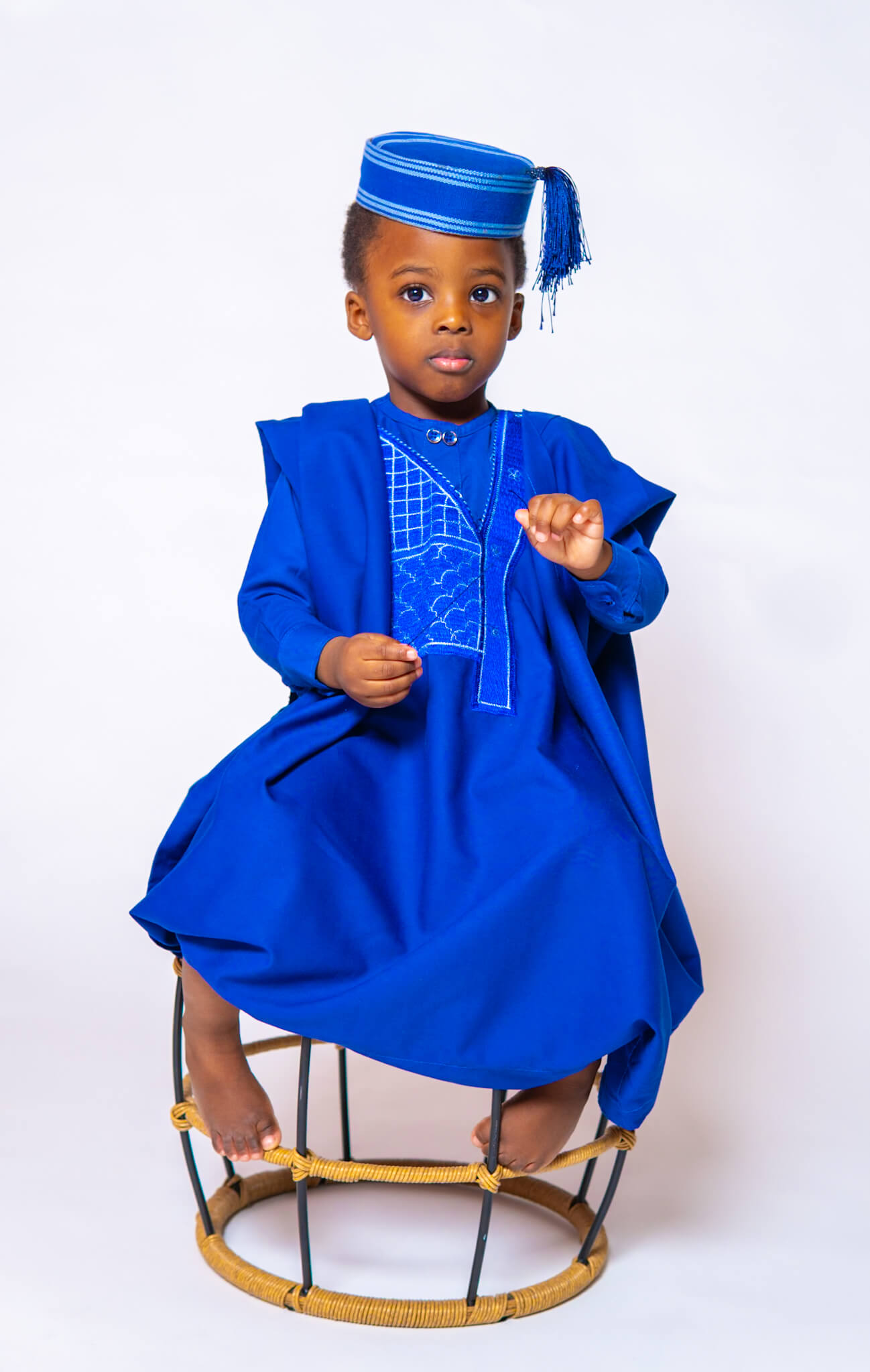 3 year old boy wearing a vibrant blue traditional Agbada and cap