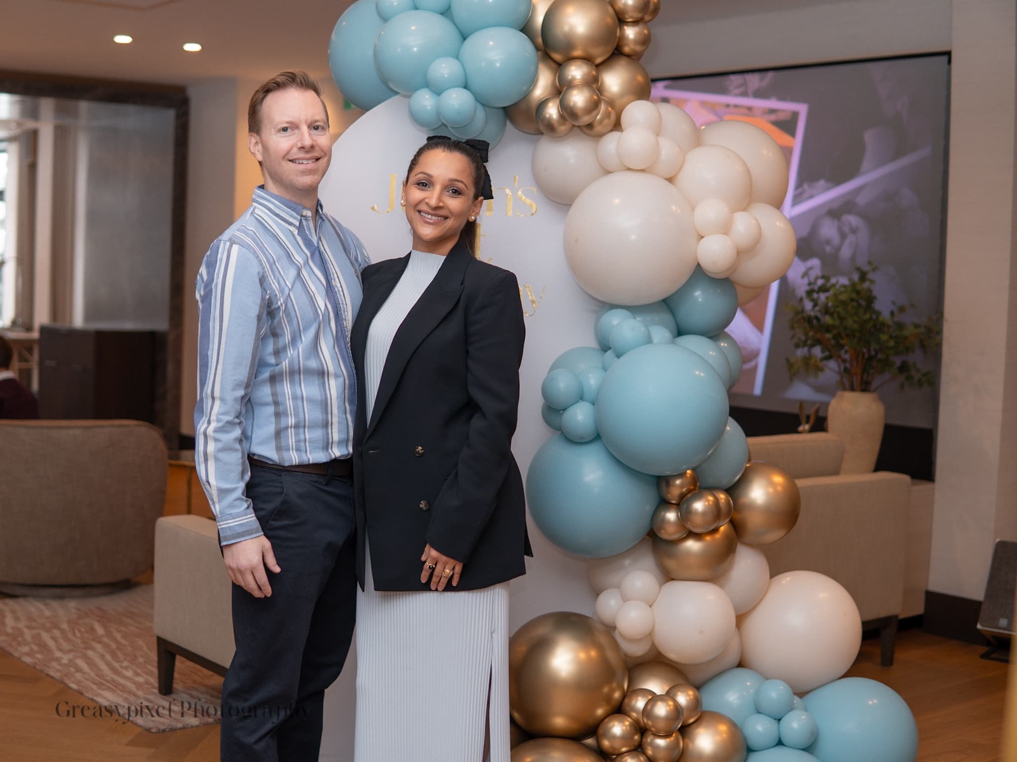 First birthday photography Waterloo Cambridge - parents holding baby
