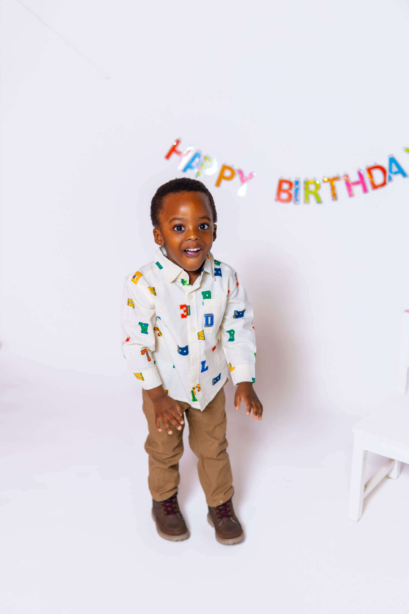 Clean white studio setup for a child's third birthday celebration